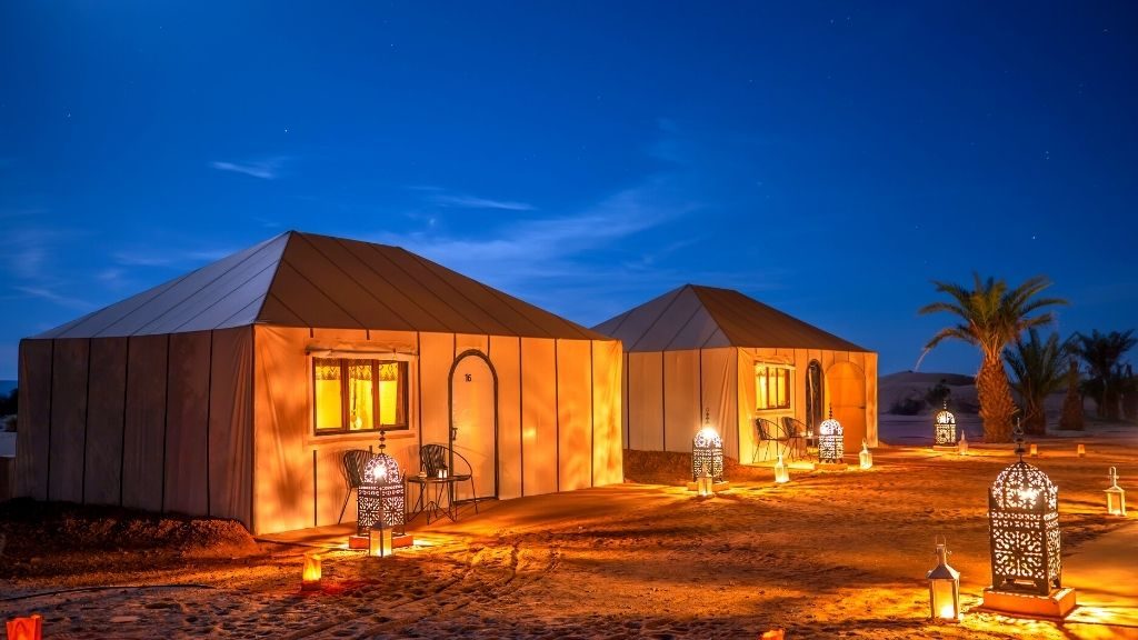 Lantern-lit tents at a luxury Sahara desert camp
